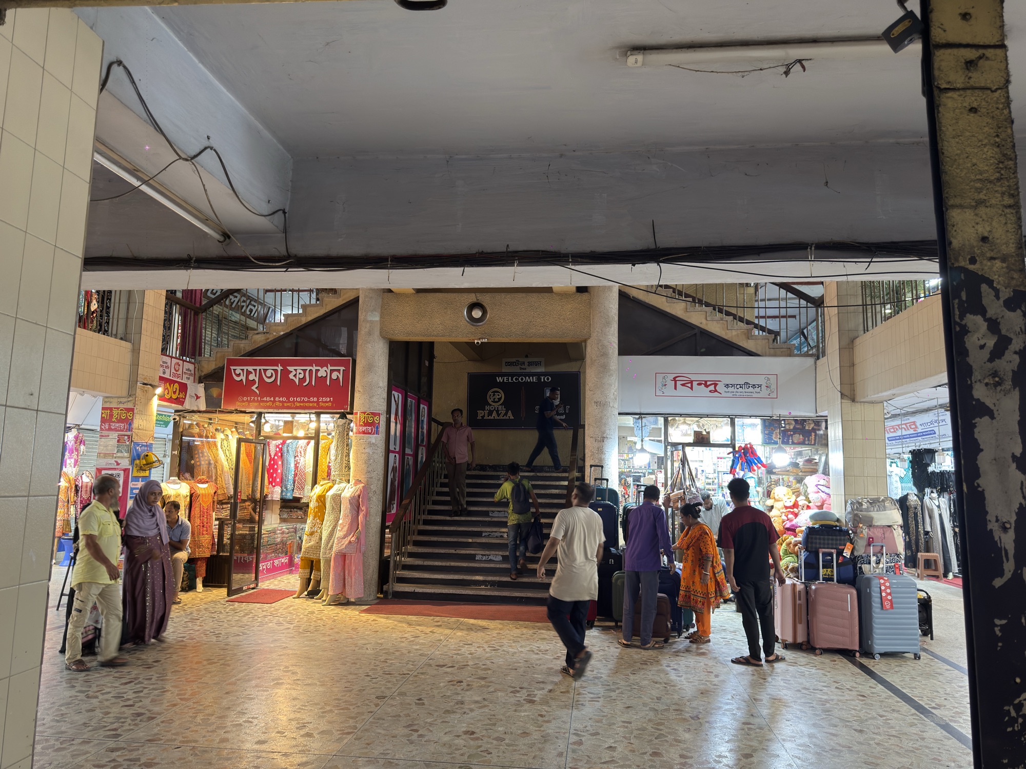 Interior corridor of Sylhet Plaza market at night.