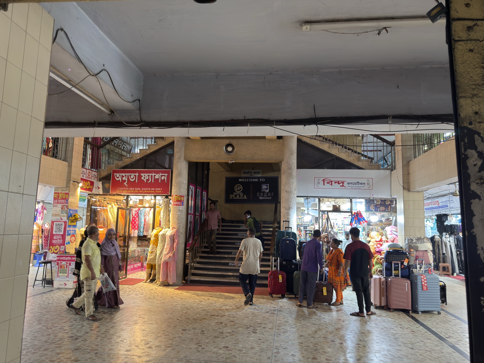 Wide photograph of the fourth-floor corridor in Sylhet Plaza.